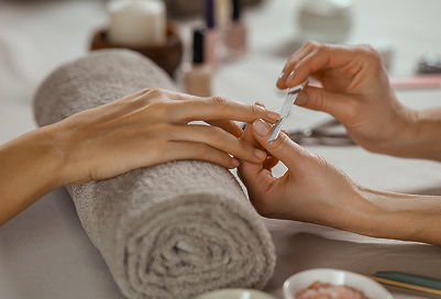 Close up of someone getting their nails filed.